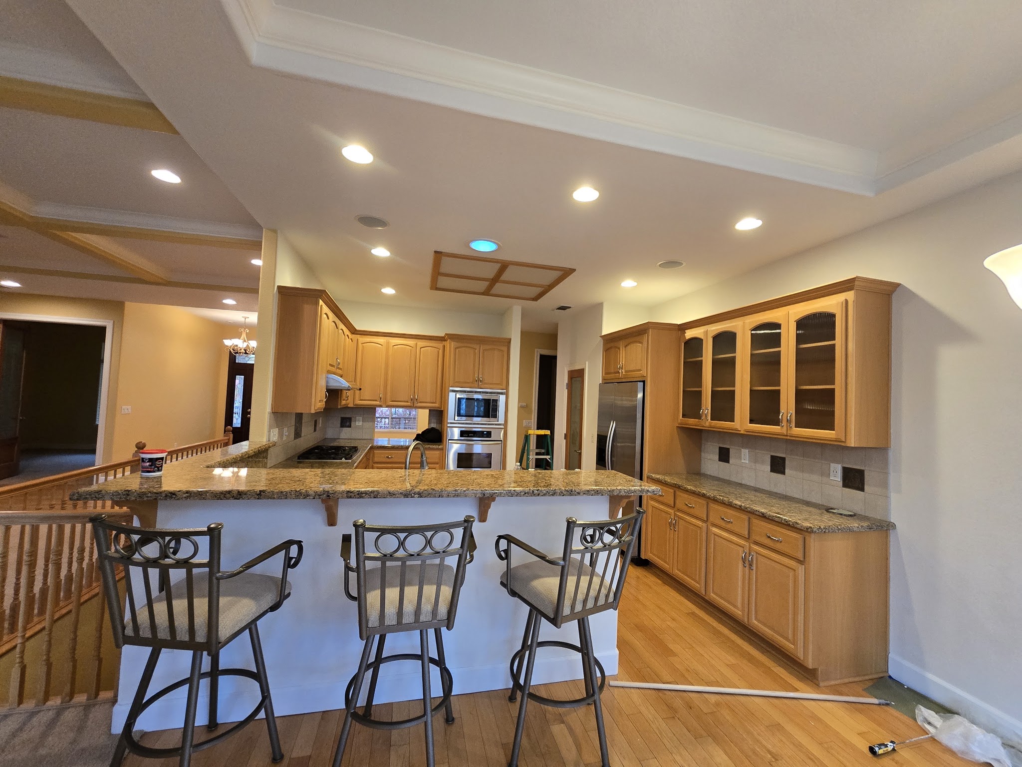 Kitchen mid-remodel with granite counters and a paint can on site